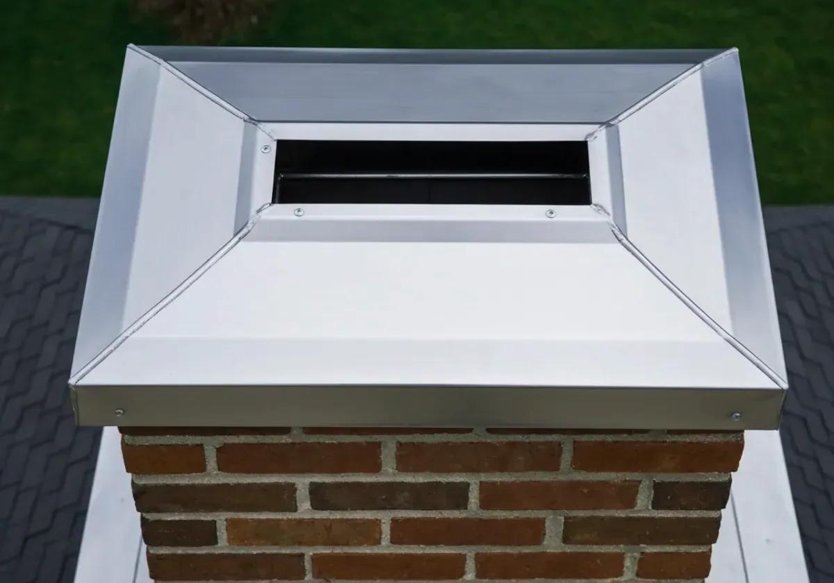 After — chimney cap installation: A bare, open flue finally given a stainless cap against the rain and the squirrels.