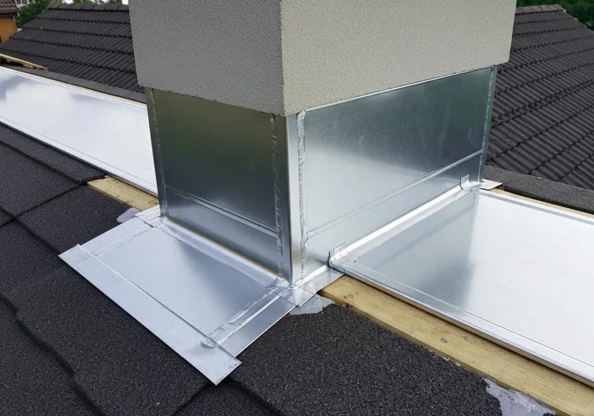 After — chimney flashing repair: Rusted, leaking flashing stripped and re-layered where chimney meets roofline.