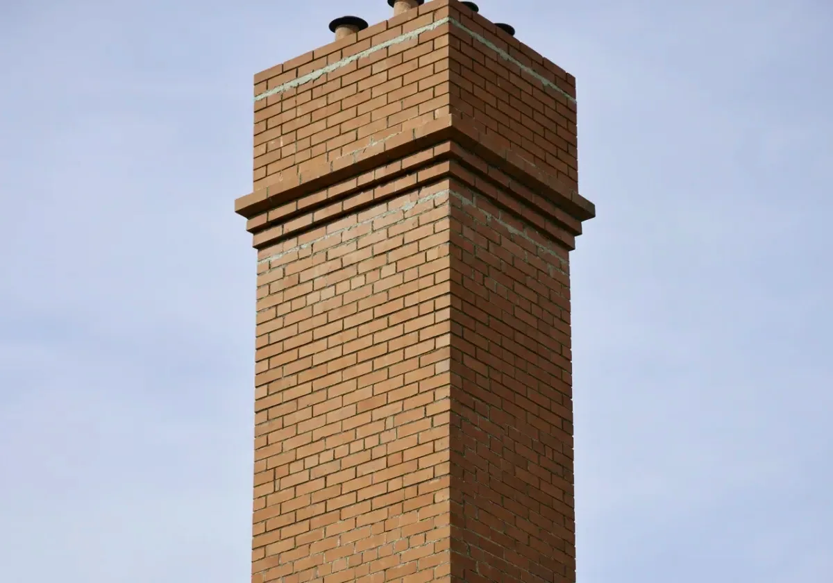 After — chimney repair: Spalled faces and washed-out joints rebuilt into a sound, weather-tight stack.