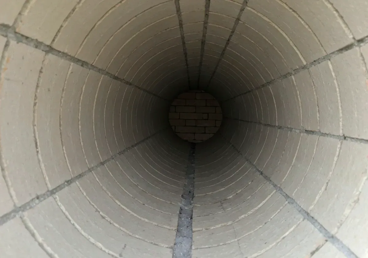 After — creosote removal: Hard, glazed creosote broken down and cleared to bare masonry — the fire risk gone with it.